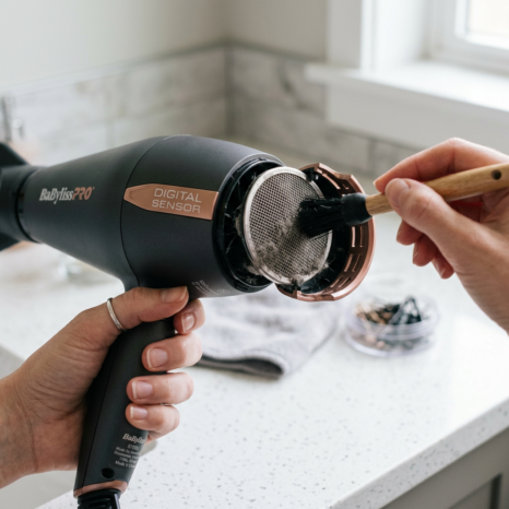 Cleaning filter of BaBylissPRO hair dryer with small brush